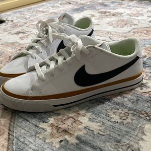 Nike White Sneakers with Black Swoosh and Gold Stripe
